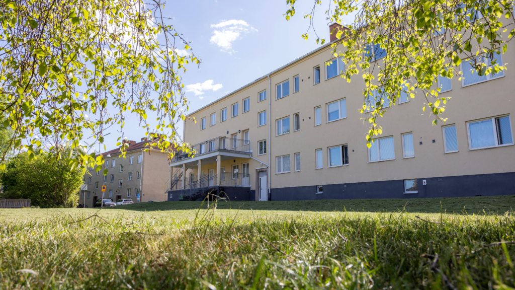 En stor byggnad med en gräsmatta framför.